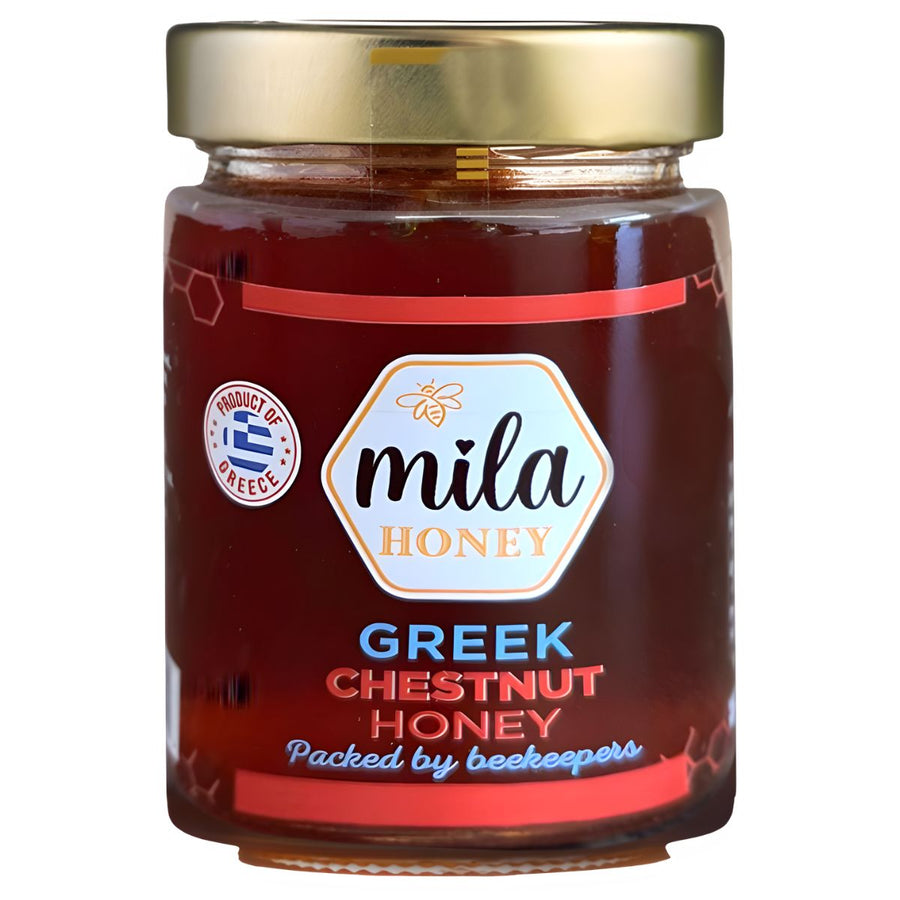 A 450g Mila Greek Chestnut Honey Jar with a gold lid, labeled “Packed by beekeepers” and a “Product of Greece” seal. This rich honey from Mila delivers exceptional Greek taste and quality.