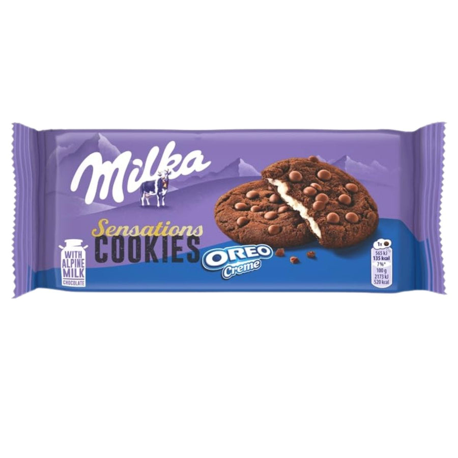 A 156g package of Milka Chocolate Cookie Sensations with Oreo Cream, showing two chocolate chip cookies with white creme filling on a purple background.