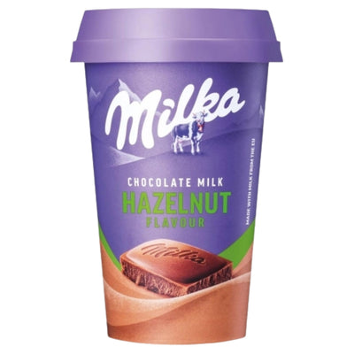 A Milka Chocolate Milk Hazelnut Flavour cup with a purple lid and purple label, featuring a chocolate milk bar graphic on a white background.