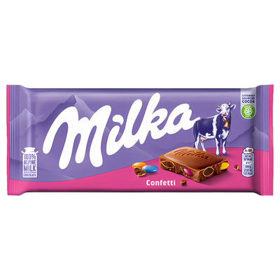 Milka - Confetti Chocolate Bar - 100g by Milka features colorful candy pieces and sprinkles on its packaging, with a cow and mountains set against a vibrant purple and pink background.