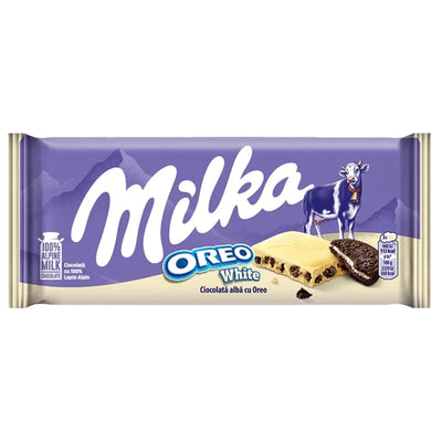 A package of Milka Oreo White chocolate wafer cookies, featuring a purple wrapper with the white 'Milka' logo, a cow illustration, and an image of the white chocolate wafer sandwiched between two Oreo cookies.
