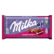 The Milka Chocolate Bar With Raspberry Creme - 100g wrapper features a charming cow image and vibrant raspberry illustration, highlighting this irresistible Alpine milk chocolate treat.