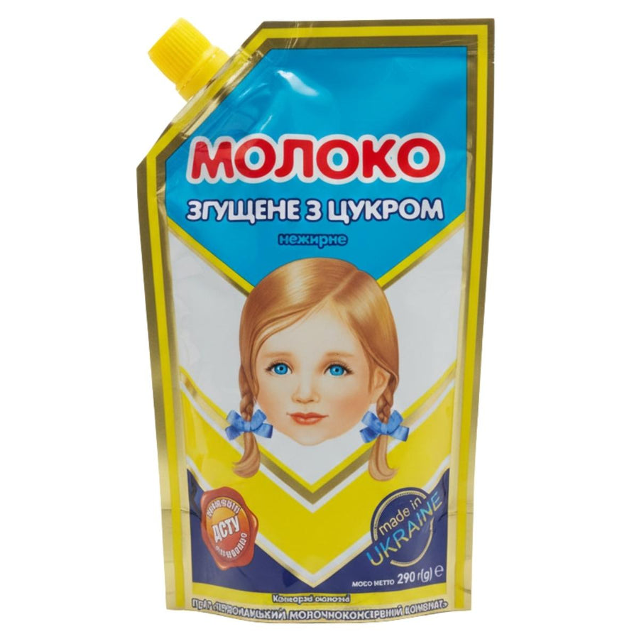 A yellow Monoko doypack of skimmed condensed milk (290g) with blue accents, a child’s face illustration, and text in Ukrainian.