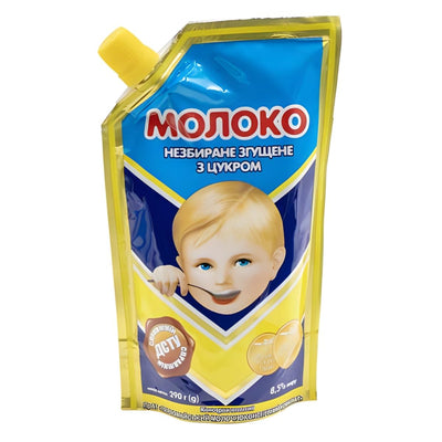 Monoko - Sweetened Condensed Whole Milk With Sugar (290g) features a cartoon child with a spoon on the Ukrainian-labeled pouch—ideal for sweetening your favorite desserts.