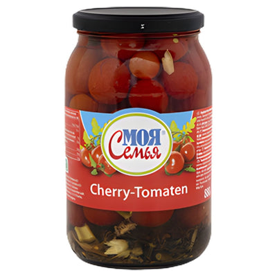 A Mor Pickled Cherry Tomatoes Jar (880g), with visible herbs and garlic, labeled in Russian and German—is ideal for Mediterranean recipes or antipasti platters.