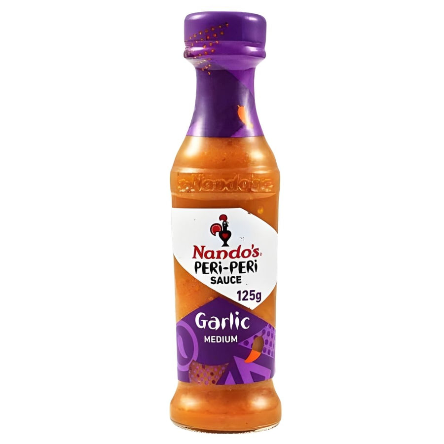 Nando's - Garlic Peri-Peri Sauce - 125g: A zesty garlic sauce ideal as a marinade or table condiment, featuring medium heat and a purple cap and label.