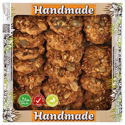 Nature Bake - Handmade Pumpkin Seed Cookies - 260g: Glucose-free, halal, and vegetarian cookies topped with mixed seeds in clear packaging labeled "Handmade"—a nutritious snack for any occasion.