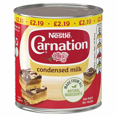 A 397g can of Nestle Carnation Condensed Milk, price marked at £2.19, with a red and yellow label—made from all natural ingredients and ideal for desserts in your kitchen.