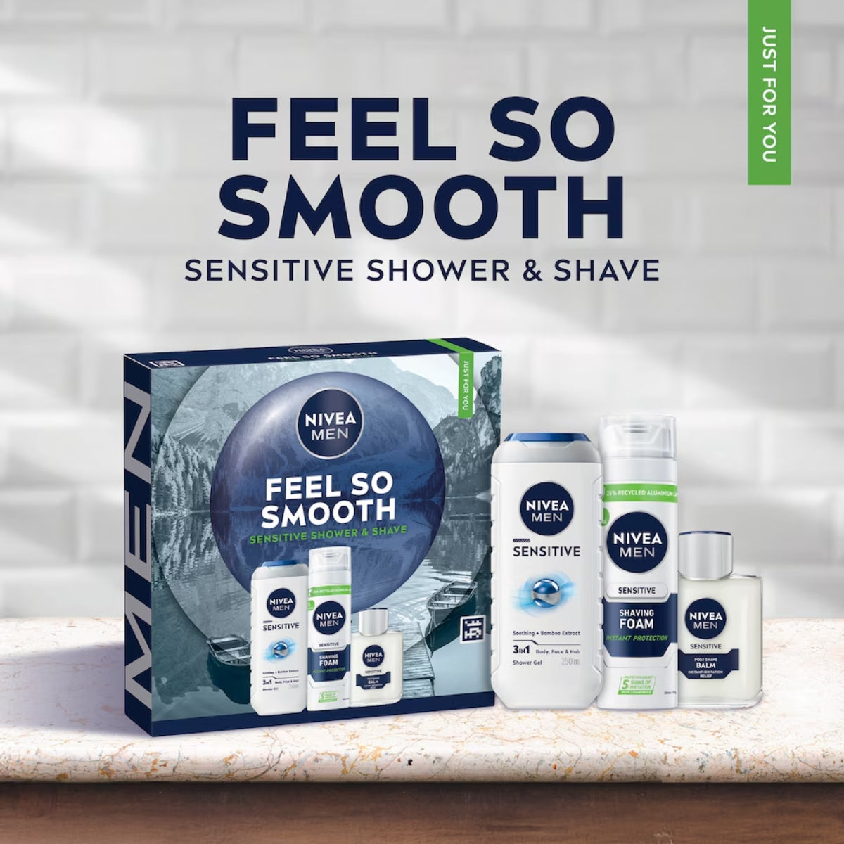 The Nivea Men - Feel So Smooth Sensitive Shower and Shave Gift Set by Nivea, featuring shower gel, shaving foam, face cream, and aftershave, is displayed on a bathroom counter.