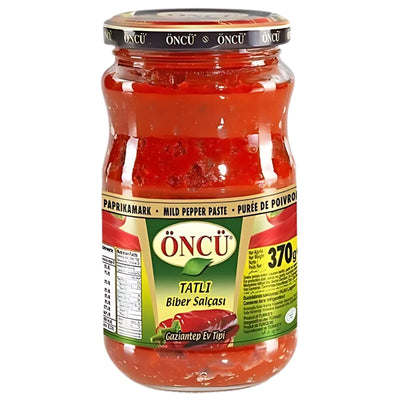 A 700g jar of Oncu Pepper Paste Mild, with clear labeling in Turkish and English, ideal for adding rich, mild pepper flavor to your favorite dishes.