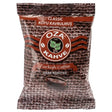 A 100g package of Oza Classic Dark Roasted Turkish Coffee features a brown woven texture background with white and red text on the front.