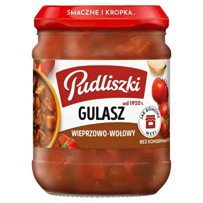 A 460g glass jar of Pudliszki Beef and Vegetable Stew, featuring a red lid, tomato images, and a Polish label with ingredients and brand details for this wholesome meal.