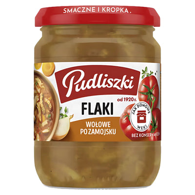 A 450g jar of Pudliszki Beef Tripe in Tomato Sauce, a traditional Polish dish by Pudliszki, comes with a red lid and label featuring tomatoes and onions.