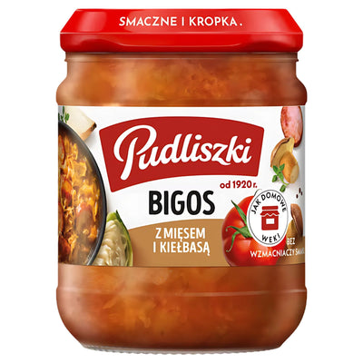 A 450g jar of Pudliszki Bigos Stewed Cabbage with Meat & Sausage, by Pudliszki, features a red lid and Polish labeling with images of traditional ingredients.