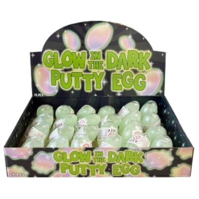 A retail display box filled with glow-in-the-dark putty eggs. The display features a black background with green text reading 'GLOW IN THE DARK PUTTY EGG' and pastel pink and green egg-shaped graphics.