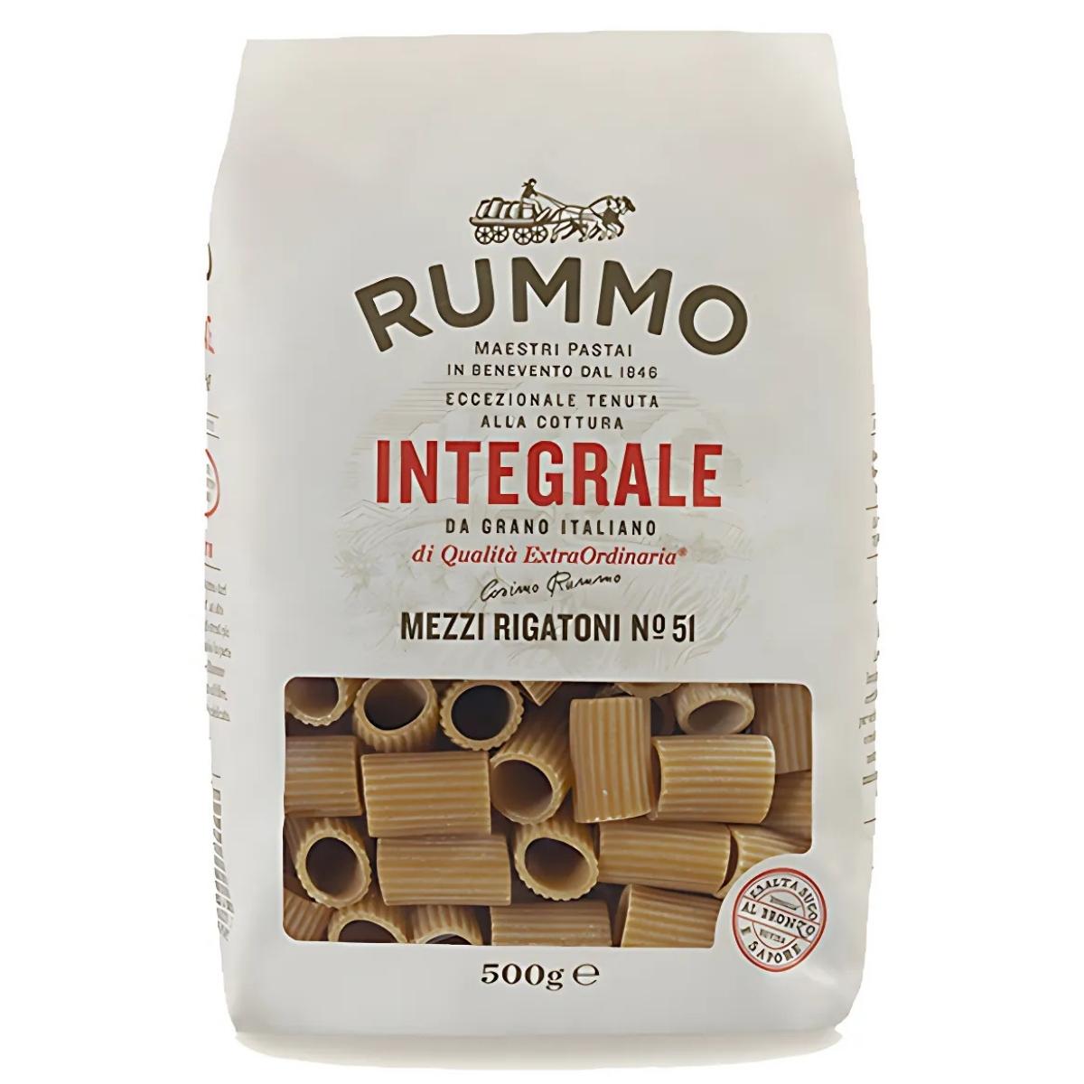 Close-up of a 500g package of Rummo Wholewheat Mezzi Rigatoni Pasta No.51, showcasing its fiber-rich wholewheat goodness. The front label has Italian text with the pasta visible through a clear window.