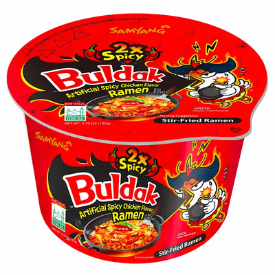 A red cup of Samyang - Buldak (2X Spicy) Hot Chicken Flavour Stir-Fried Ramen Big Bowl (Halal, 105g), featuring cartoon chicken and fiery flames on the packaging.