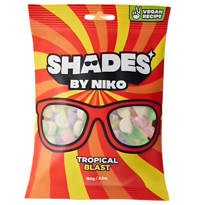 A 150g bag of Shades - Tropical Blast vegan candies by Shades, featuring a red and orange sunburst design with black sunglasses, offers tropical fruit flavors like mango, passion fruit, and pineapple.