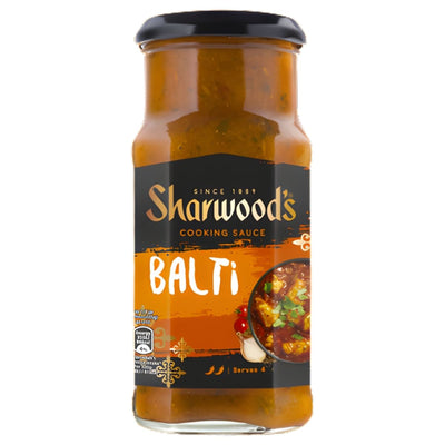 A 420g glass jar of Sharwood’s Balti Cooking Sauce with a black lid and orange label, showing an image of curry and serving suggestions for this vibrant, tomato-based sauce.