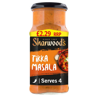Sharwood's Tikka Masala sauce in a clear glass jar with a black lid and a black, orange, and yellow label, shown on a white background.