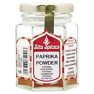 A clear glass jar of Sita Spices - Paprika Powder - 30g with a white and red label featuring spice details and ingredients in multiple languages.