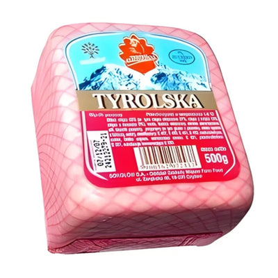 Sokolow Tyrolska (Pork) Mini Block is a 500g ham sausage made from finely minced pork, poultry, and beef, wrapped in a pink inedible casing with a blue and red label showing product details.