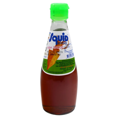 Squid Brand Fish Sauce (300ml) comes in a clear glass bottle with a green cap, ideal for adding authentic Southeast Asian flavour to your Thai dishes.