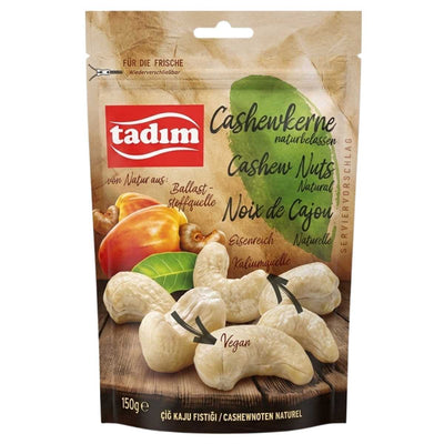 A 150g resealable pack of Tadim Unroasted Natural Cashew Nuts, with images of whole cashews and product info in German, English, and French on the front.