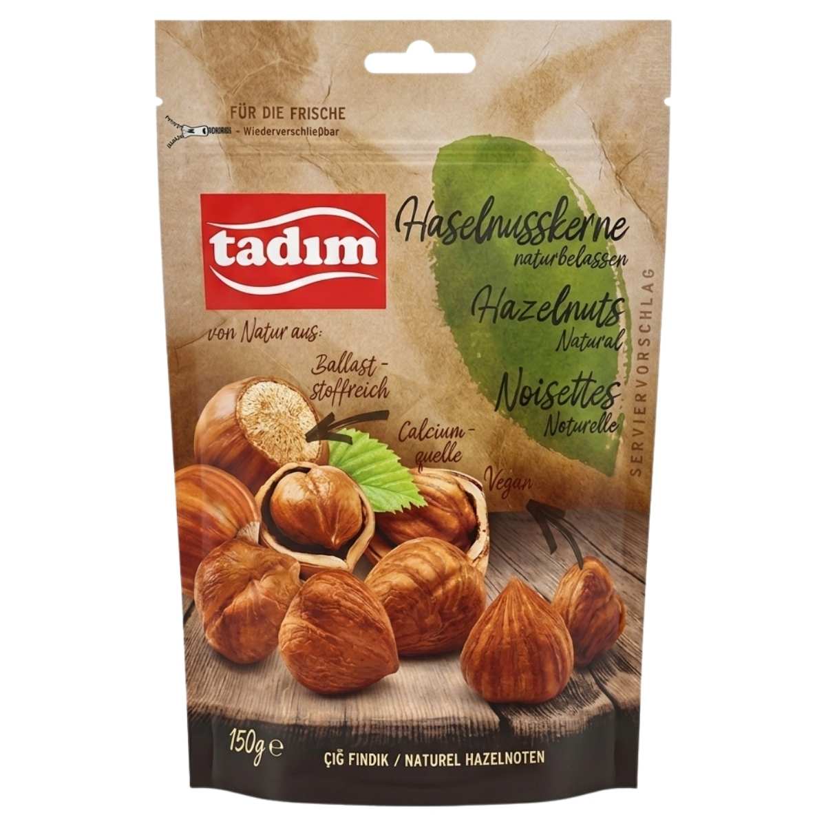 A 150g pack of tadim Unroasted Natural Hazelnuts featuring images of hazelnuts and product info in German, French, and Turkish on the packaging.