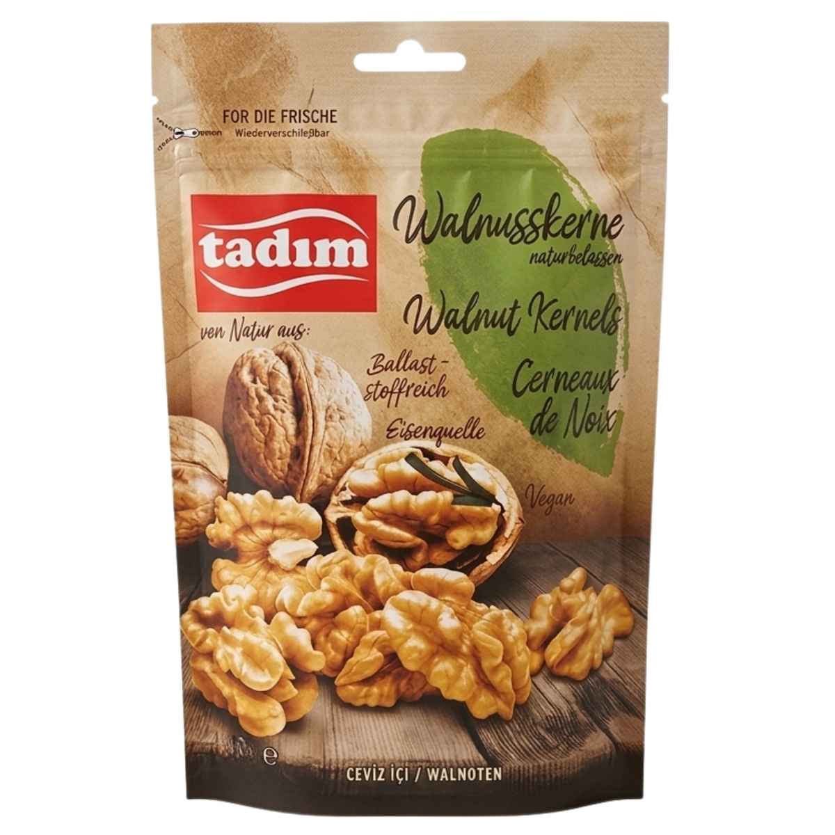 A resealable 140g pack of tadim Unroasted Natural Walnut Kernels is shown, with images of whole and shelled walnuts, plus text noting they're vegan and a source of iron.