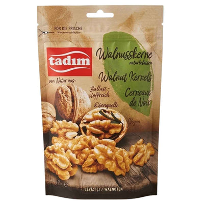 A resealable 140g pack of tadim Unroasted Natural Walnut Kernels is shown, with images of whole and shelled walnuts, plus text noting they're vegan and a source of iron.