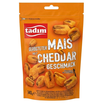 A resealable orange 140g Tadim bag labeled "Roasted Corn with Cheddar Flavour" features images of corn snacks and German text describing the product.