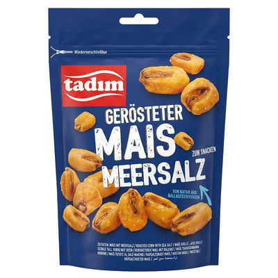 A blue, resealable Tadim - Roasted Corn with Sea Salt bag featuring roasted corn kernels and German text reading “Gerösteter Mais Meersalz.”