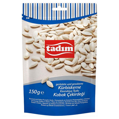 A 150g pack of tadim Roasted & Salted Pumpkin Seeds, rich in plant-based protein. The packaging displays salted pumpkin seeds and product info in several languages.