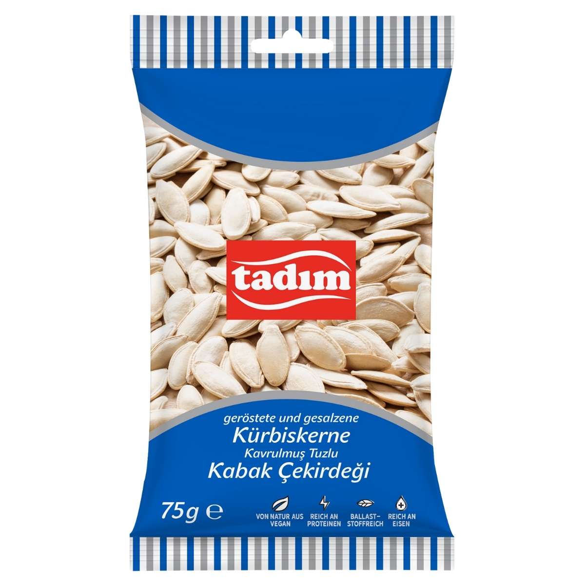 A 75g pack of tadim Roasted & Salted Pumpkin Seeds, a healthy snack, with German and Turkish labeling on a white and blue background.