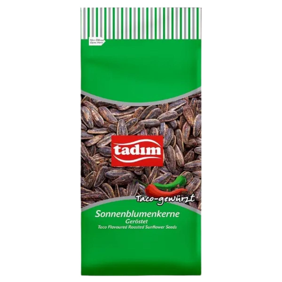 A green 150g package of tadim Taco Flavoured Roasted Sunflower Seeds features images of seeds and a red chili on the front.