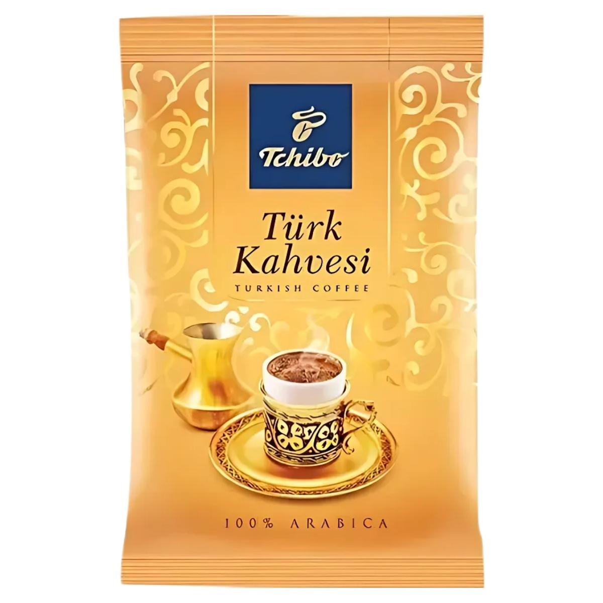 The Tchibo - Turkish Coffee - 100g package features a cup of genuine Turkish coffee beside a beautifully designed cezve with intricate gold patterns. The label prominently states "100% Arabica," guaranteeing an authentic flavor in every cup.