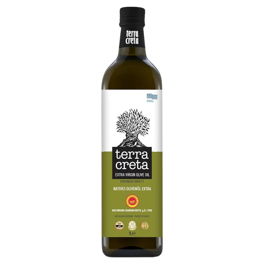 A 1-liter bottle of Terra Creta Premium P.D.O. Kolymvari Extra Virgin Olive Oil, from Greece, features a green and white label with an olive tree illustration and several quality certification seals.