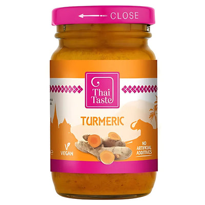 A 114g jar of Thai Taste Tumeric with a pink lid and orange label, featuring turmeric roots and icons for vegan and no artificial additives—ideal for bringing authentic minced turmeric flavor to Thai cuisine.