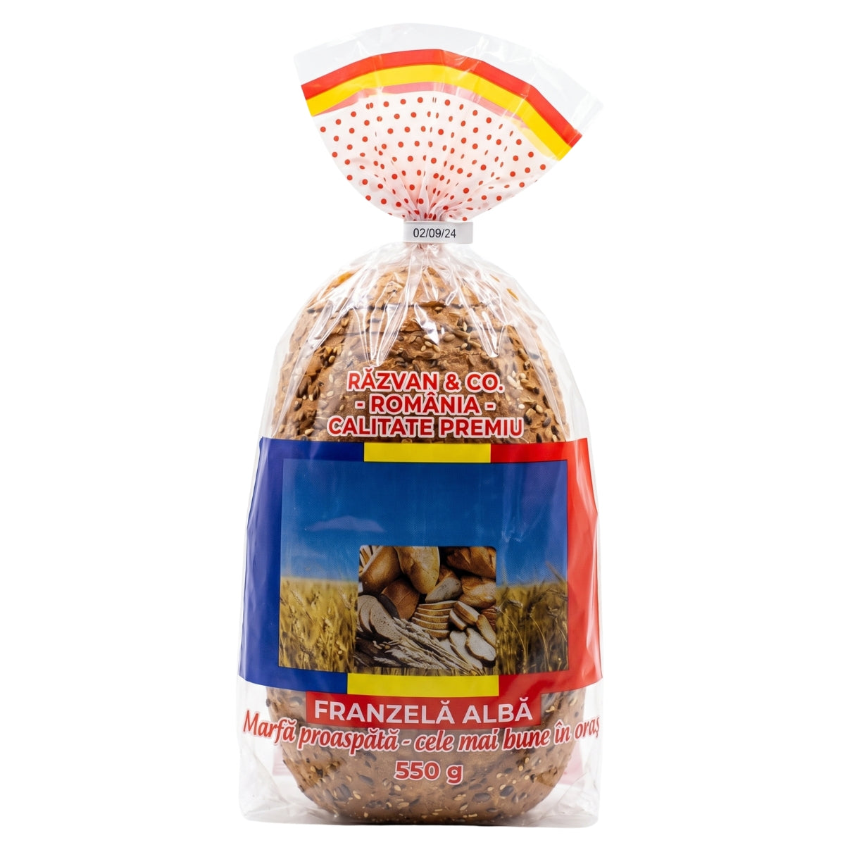 A 550g loaf of Franţelă Albă (Albanian white bread) in a clear plastic bag with a decorative red, yellow, and white polka-dot top seal and a blue, red, and yellow paper label. The label features the text 'RĂZVĂN & CO.