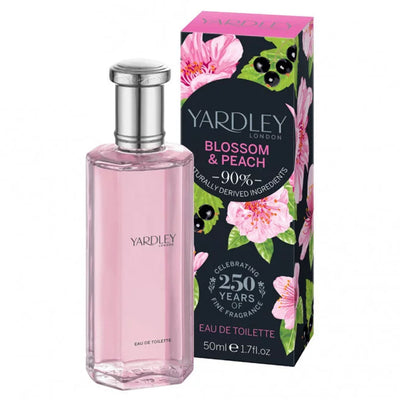 A 50ml bottle of Yardley Of London - Blossom & Peach Eau De Toilette Spray is displayed beside its floral box, showcasing 90% naturally derived ingredients.