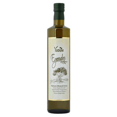 A tall, dark green glass bottle of Yudum Extra Virgin Olive Oil (Egemden), 500ml, with a cream-colored label featuring an olive tree illustration.