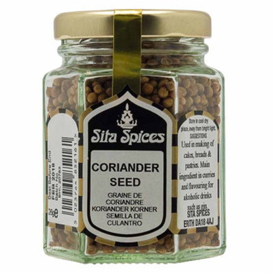 A 26g glass jar of Sita Spices - Ground Coriander with a gold lid and label displaying product details and usage instructions.