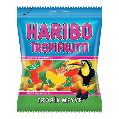 A pack of Haribo Tropifrutti 80g gummy candy by Haribo, featuring colorful fruit-shaped gummies, a toucan illustration, and Turkish text on the packaging.