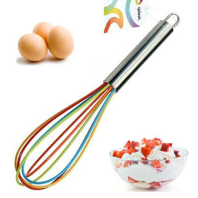 The Splash - Apollo Silicone Whisk 25cm by Splash is shown with three eggs and a glass bowl of whipped cream topped with strawberries.