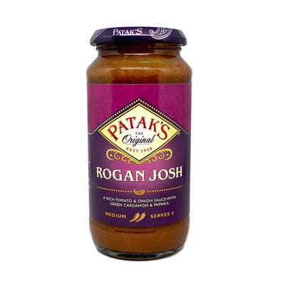 A 450g jar of Patak's Rogan Josh Cooking Sauce, labeled "medium" and "serves 4," is perfect for making authentic Indian curry at home.