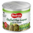A 400g can of Bodrum Stuffed Vine Leaves, a Mediterranean appetizer called "Yaprak Sarma," features nutritional info and a 100% quality badge on the front.