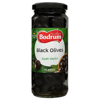 A 680g glass jar of Bodrum Whole Black Olives in brine, featuring a green and white label with black olive images.