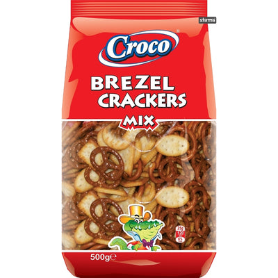 Croco Brezel Crackers Mix 500g by Croco features savoury crackers, such as crunchy pretzels and ovals, in a bag with a green cartoon crocodile on the packaging.