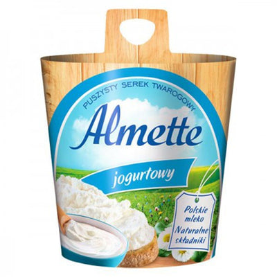 Hochland Almette Soft Cheese with Yogurt (150g) features a blue and white label, cheese image, and green field background; text highlights Polish milk and natural ingredients for a fresh, creamy taste.